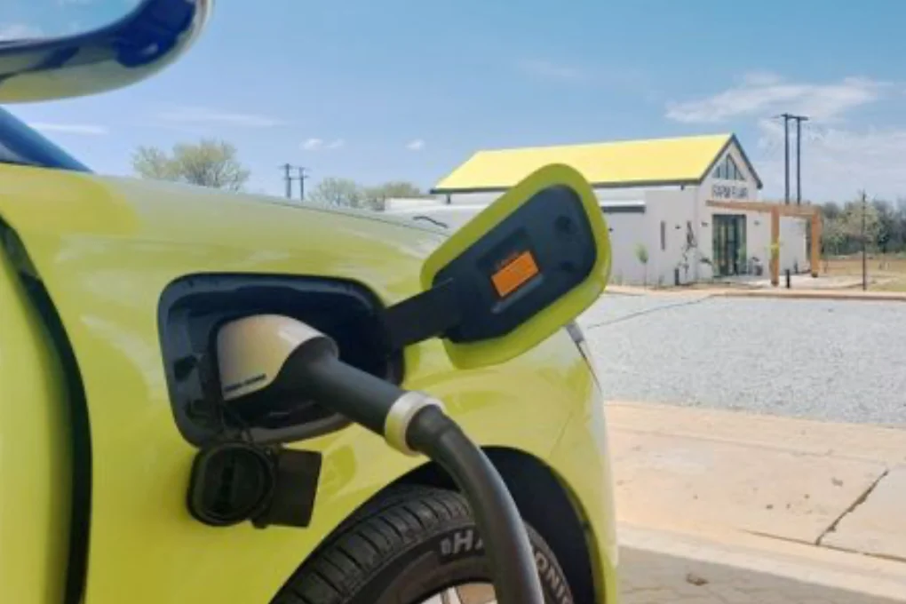 An electric car charging at a roadside stop